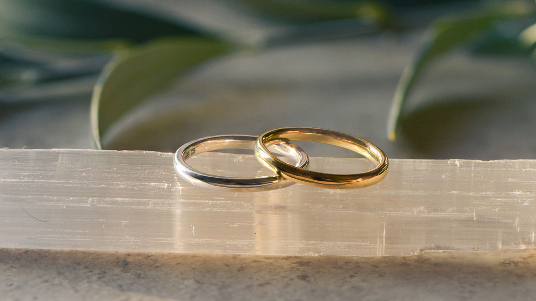 Two wedding rings, one gold and one platinum, on a natural background 