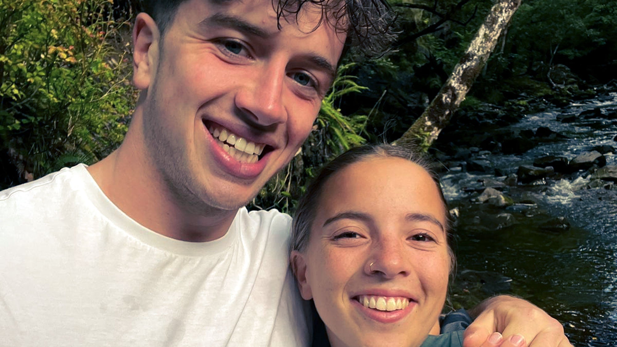 a couple happy in the woods after a proposal