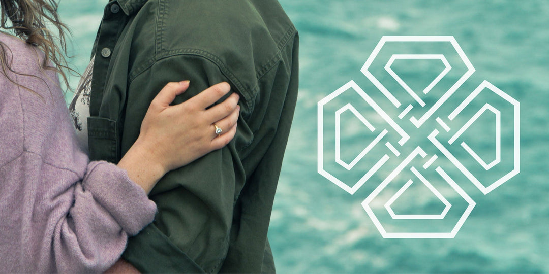 A Celtic logo against the background of the sea with a couple embracing