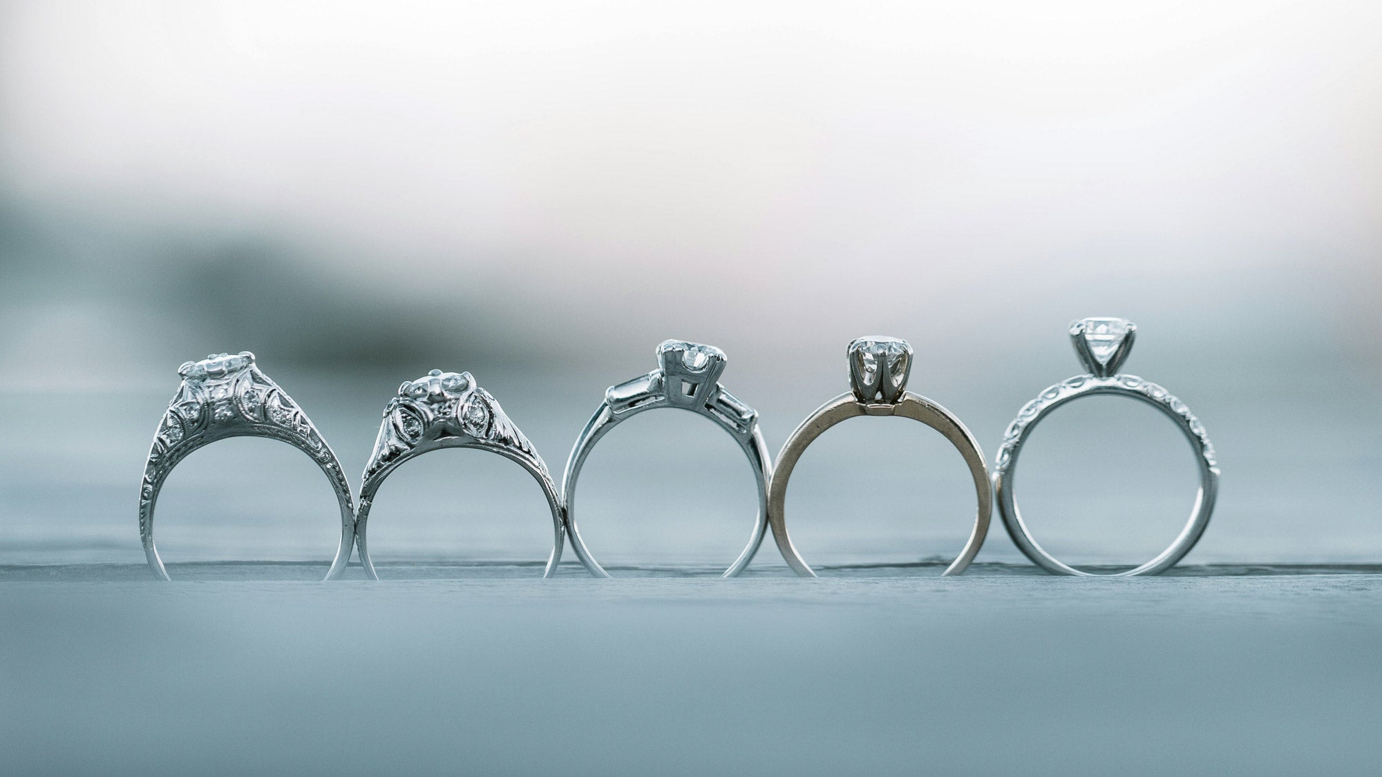 Side profile of multiple engagement rings showing their different setting and shank styles
