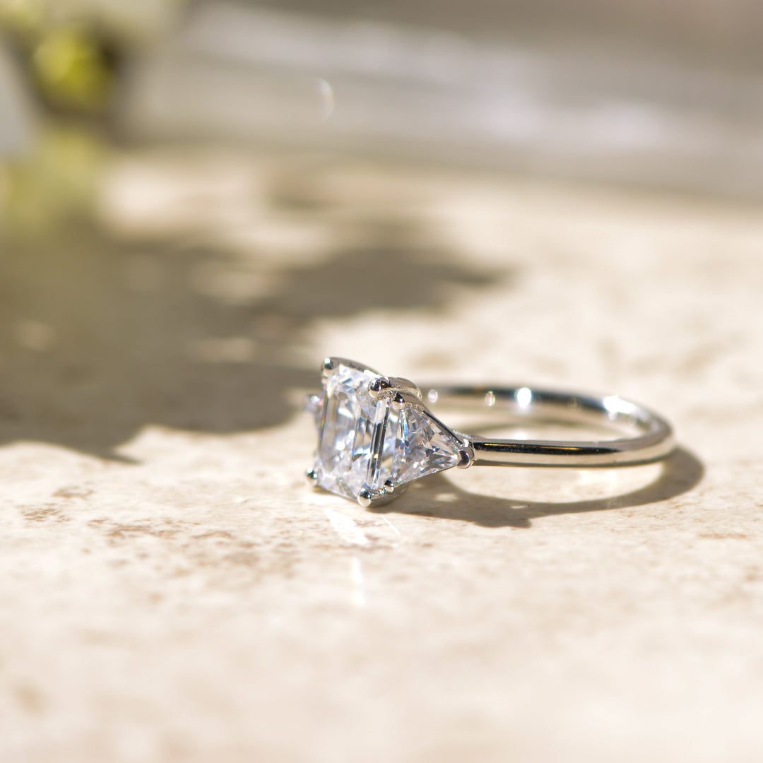 Diamond trilogy ring on a marbled surface