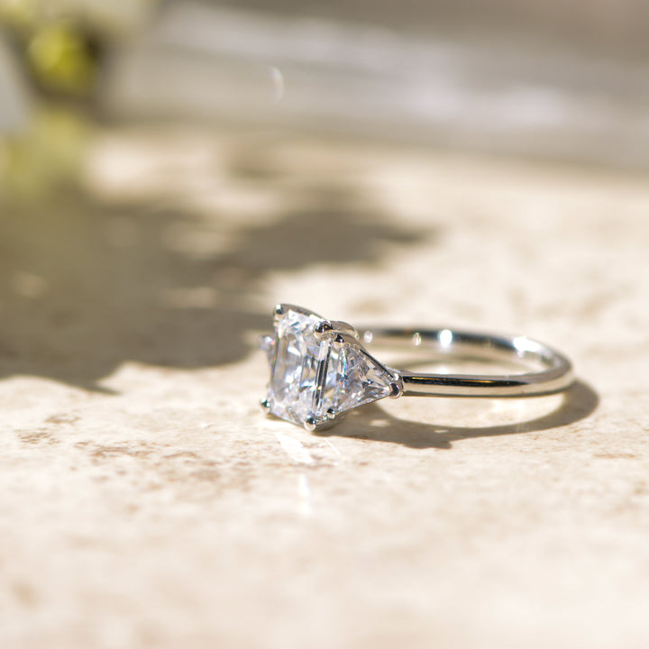 Diamond trilogy ring on a marbled surface