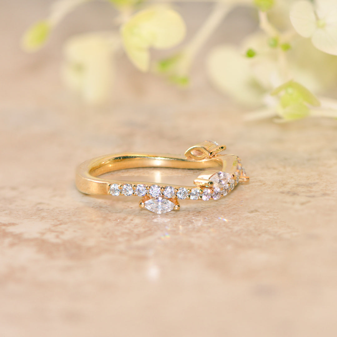Gold ring with diamonds on a soft beige background