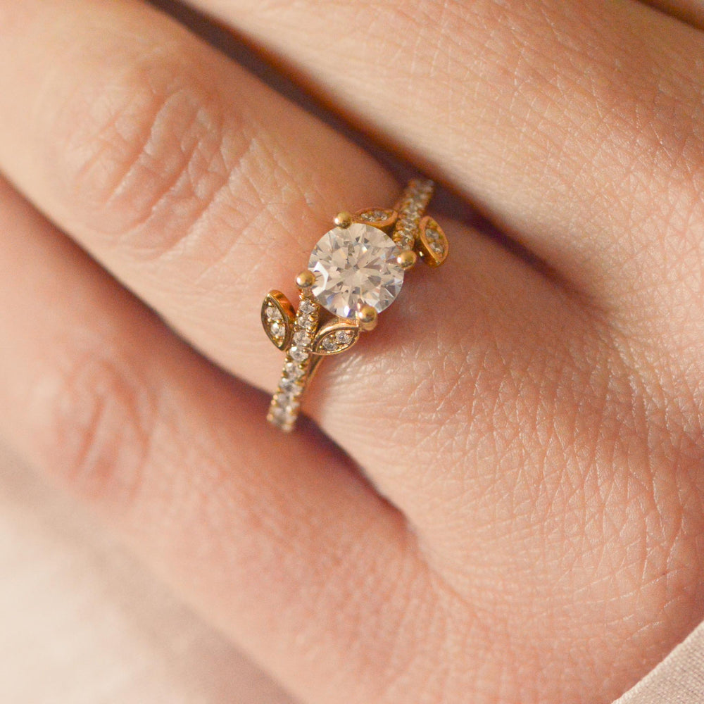 Gold ring with a large diamond on a person's finger