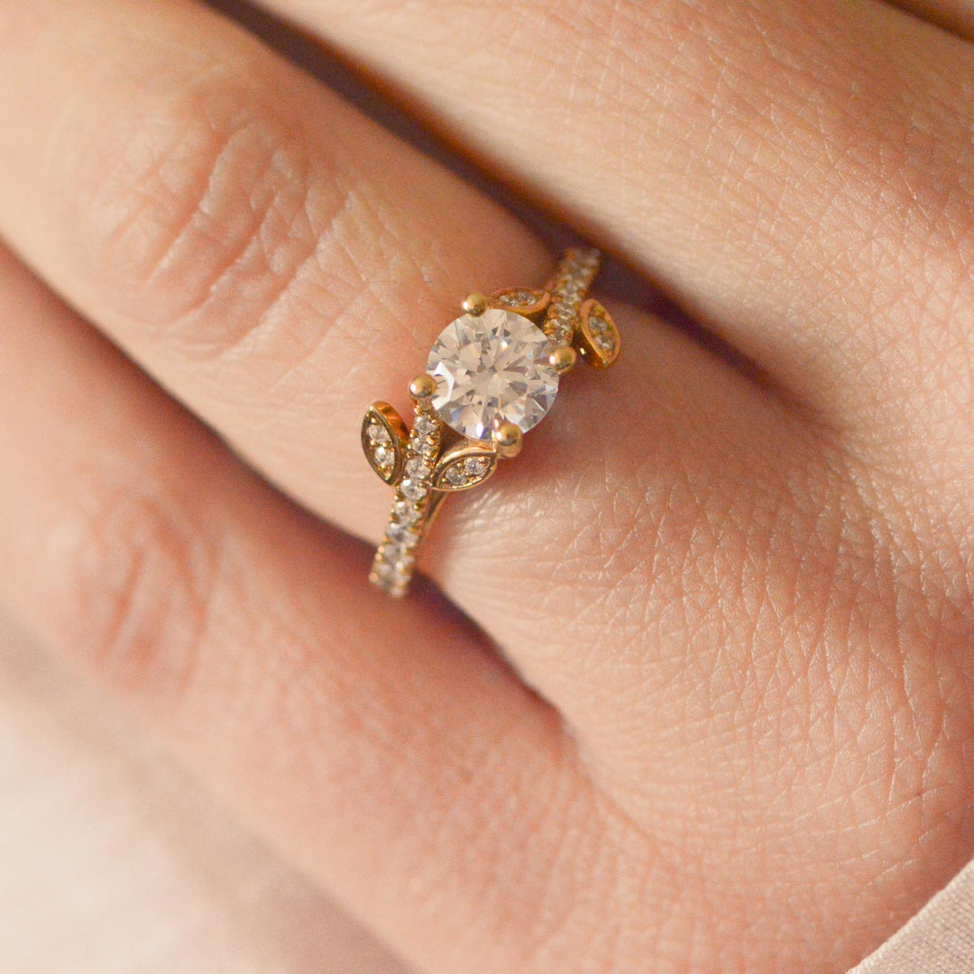 Gold ring with a large diamond on a person's finger