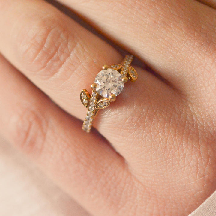 Gold ring with a large diamond on a person's finger