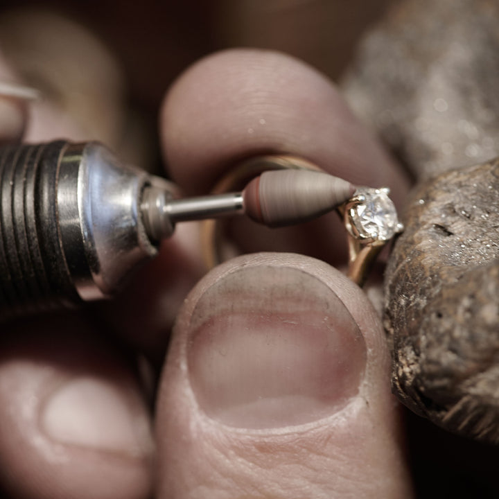 Close-up of a lab grown diamond being set into a bespoke engagement ring.