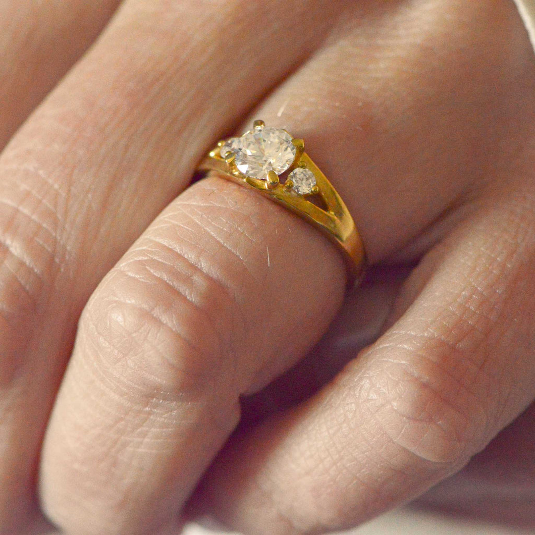 Gold ring with a diamond on a finger