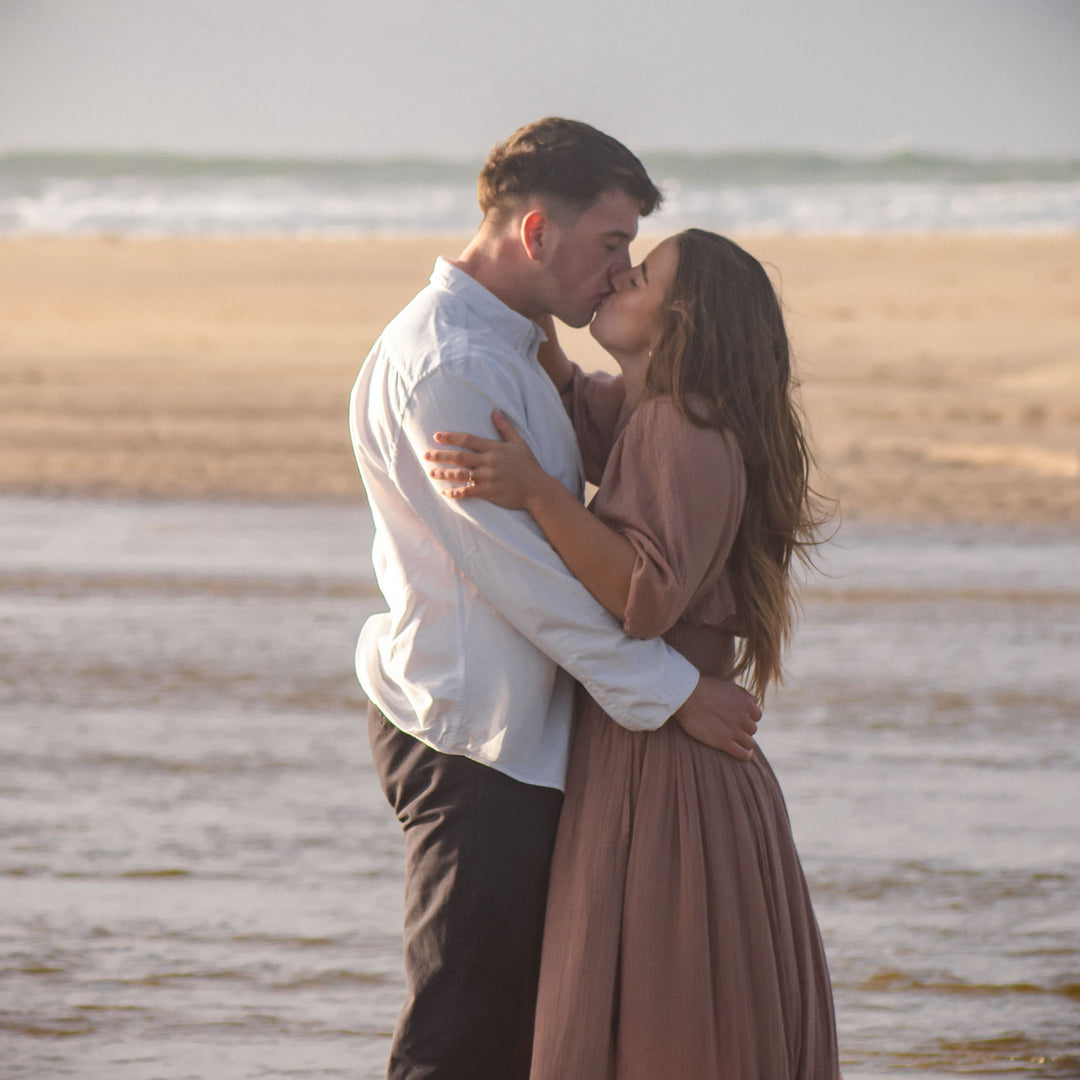 Couple embracing on a beach with a blurred background