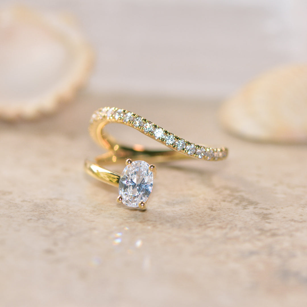 Gold ring with a diamond on a beige background