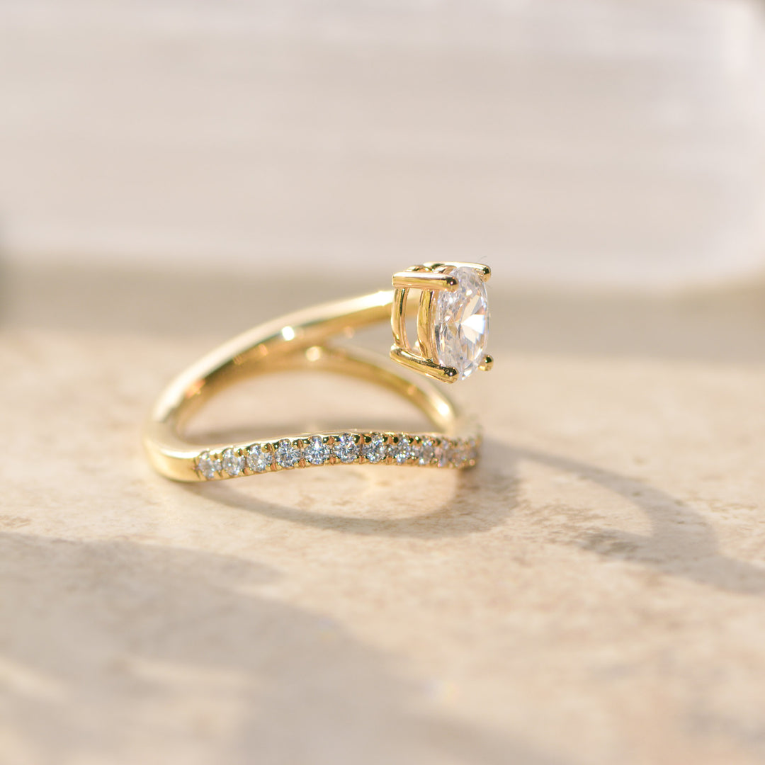 Gold ring with a diamond on a light background