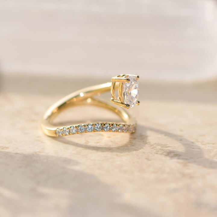 Gold ring with a diamond on a light background