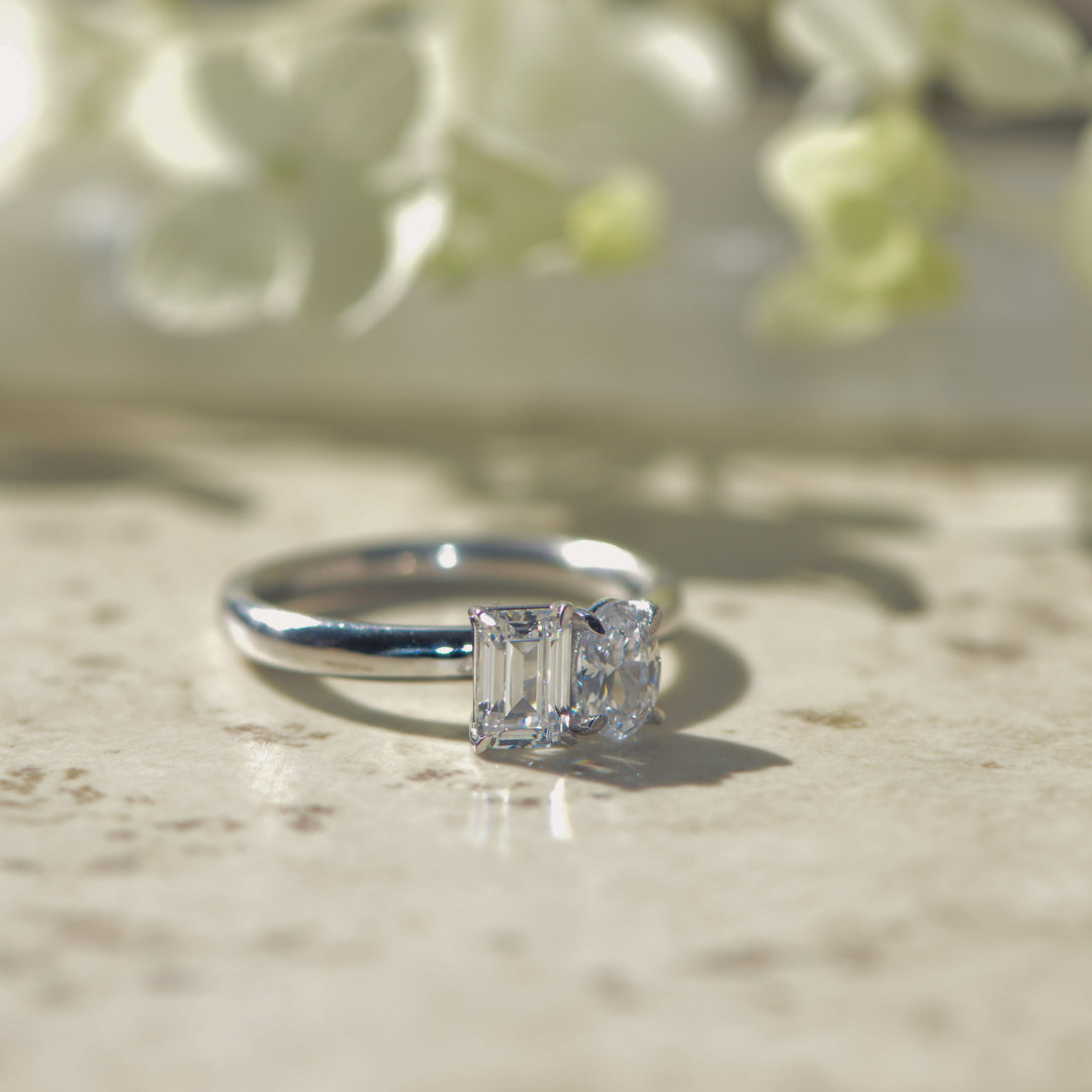 Diamond ring on a textured surface with a blurred floral background