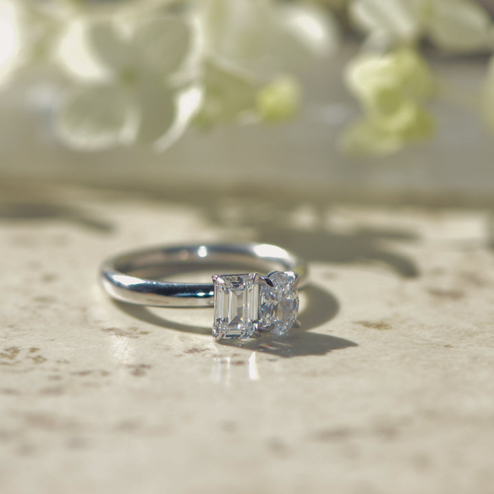 Diamond ring on a textured surface with a blurred floral background