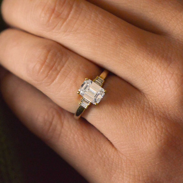 Gold ring with a large diamond on a person's finger