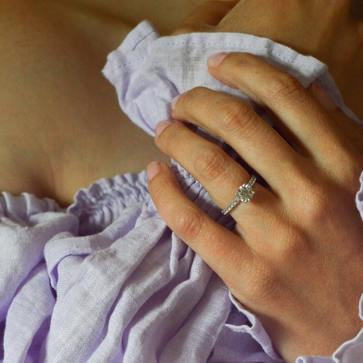 Round brilliant cut diamond engagement ring worn on the hand