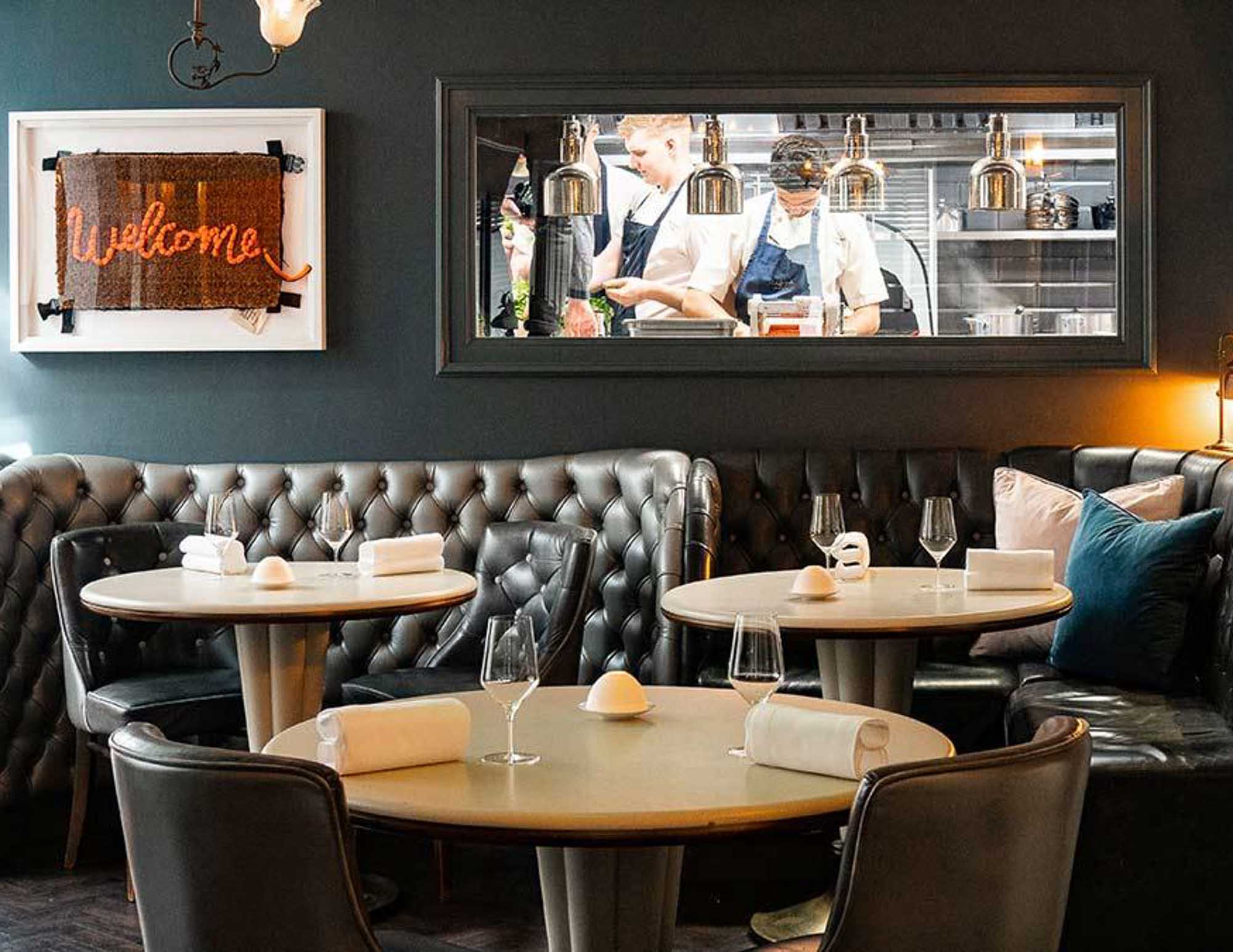 Cornish Restaurant interior with tables, chairs, and a hatch in to the Kitchen.