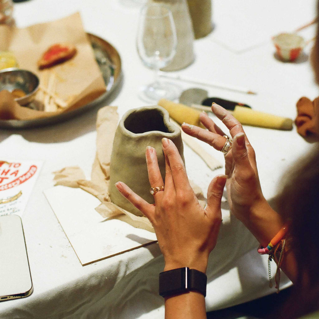 Person working with clay to hand-make a jug  in a Cornish pottery workshop.