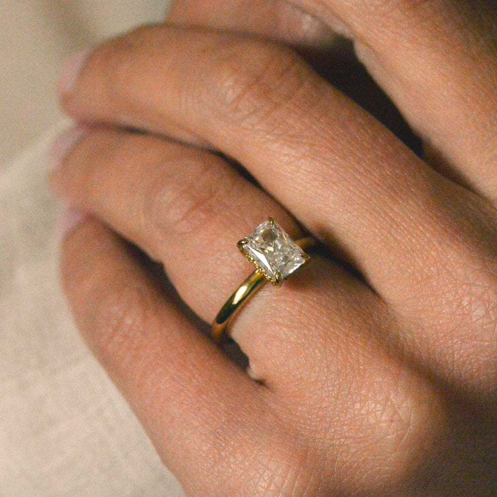 Radiant cut engagement ring worn on the hand
