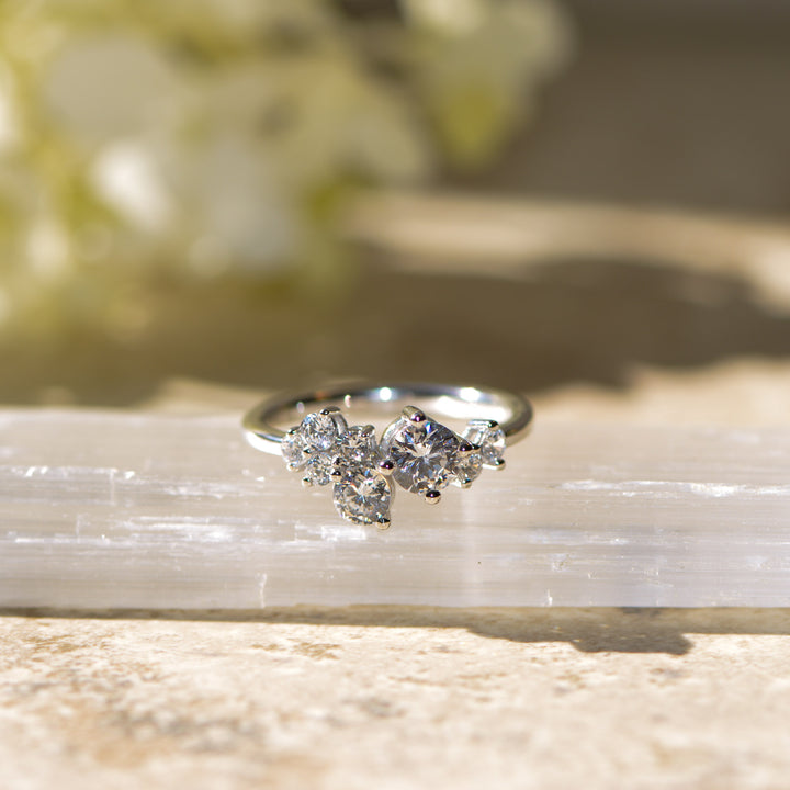 Multi stone platinum ring set with diamonds on a crystal surface