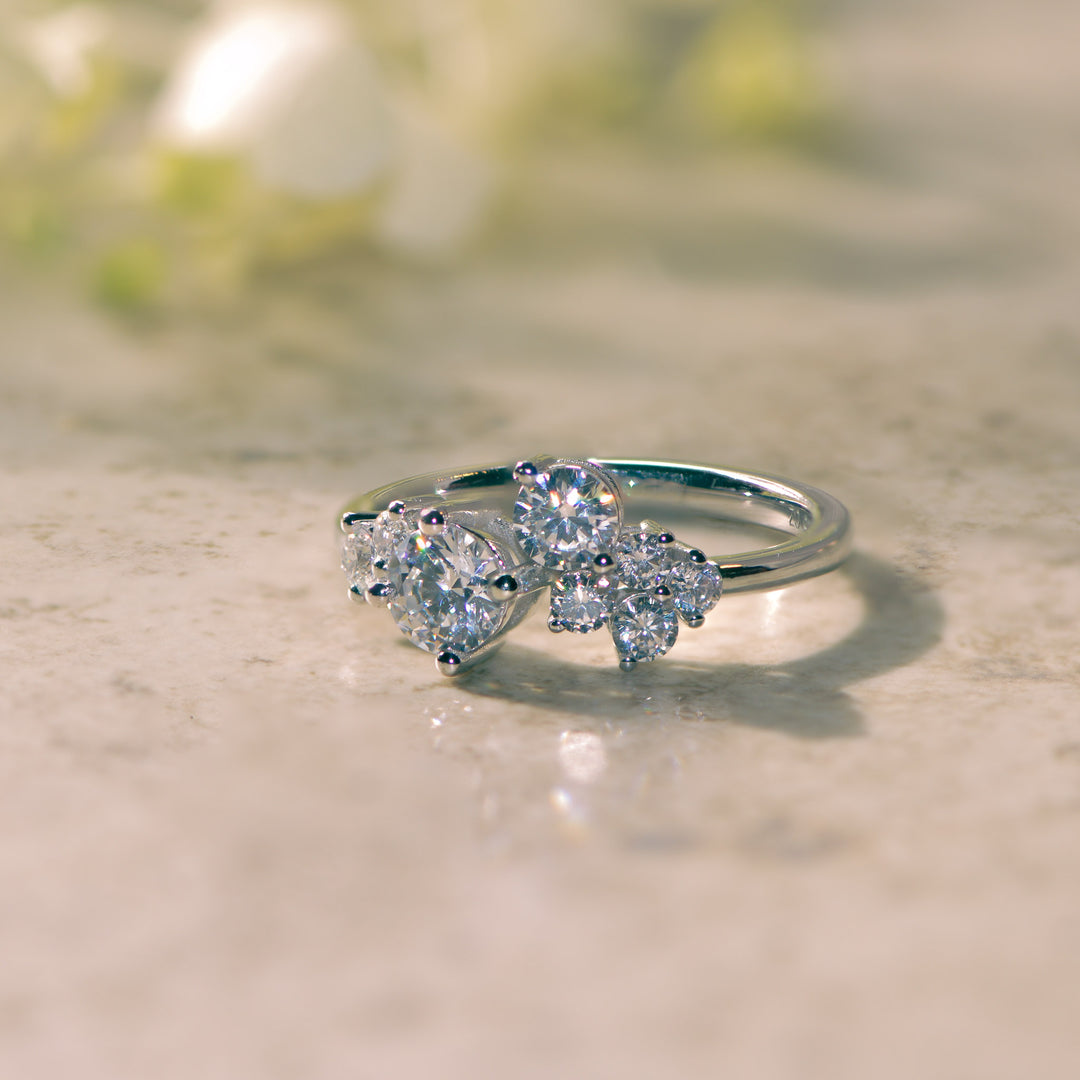 Platinum ring set with a cluster of diamonds on a light background