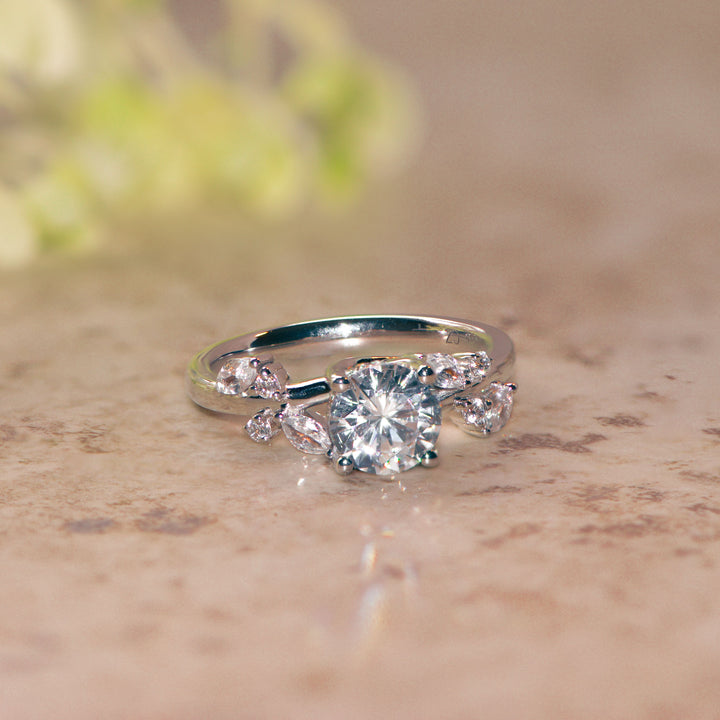 Platinum engagement ring with a large diamond  on a beige surface