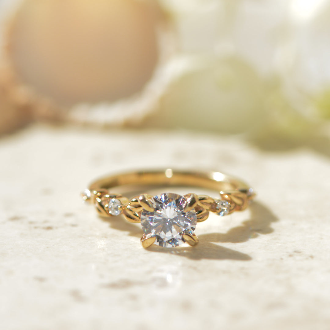 Gold ring with a diamond on a light background