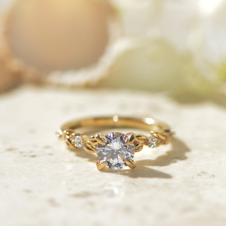 Gold ring with a diamond on a light background