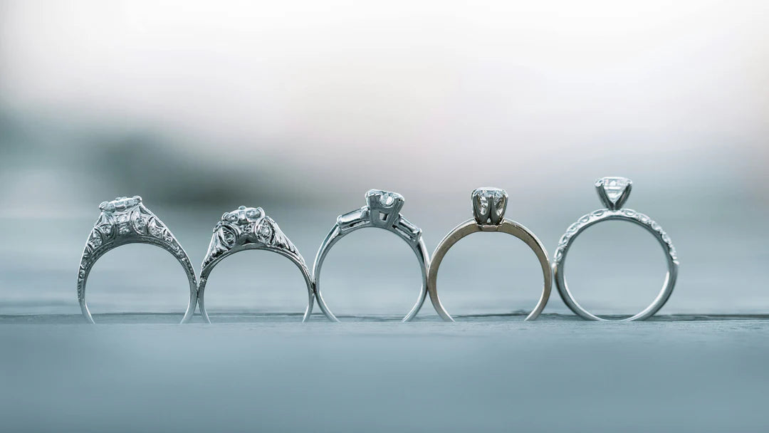 Line up of 5 different styles of engagement rings 